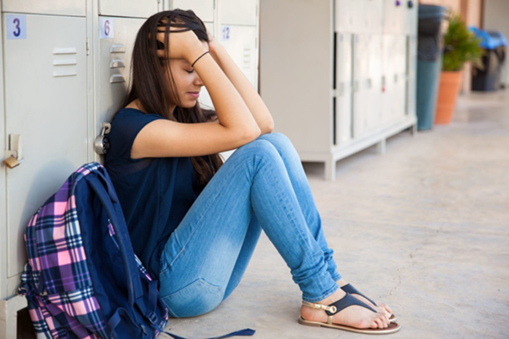 girl-sitting-next-to-locker